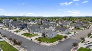 Residential neighborhood featuring a mix of single-family homes with diverse architectural styles, concrete streets, and mature landscaping