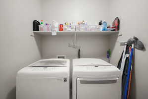 Dedicated laundry area with a white wall-mounted shelf