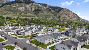 Residential neighborhood featuring multiple single-family homes with pitched roofs and varying exterior finishes