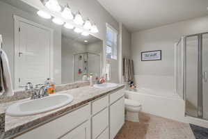 Double vanity with undermount sinks, chrome fixtures, and a granite-finish countertop