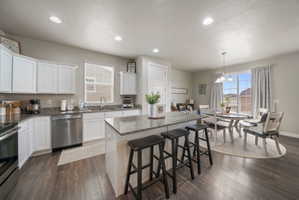 Kitchen and dining area featuring wood-finish flooring