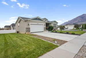 Contemporary-style exterior with a two-car garage, stone accents, and a covered porch entry