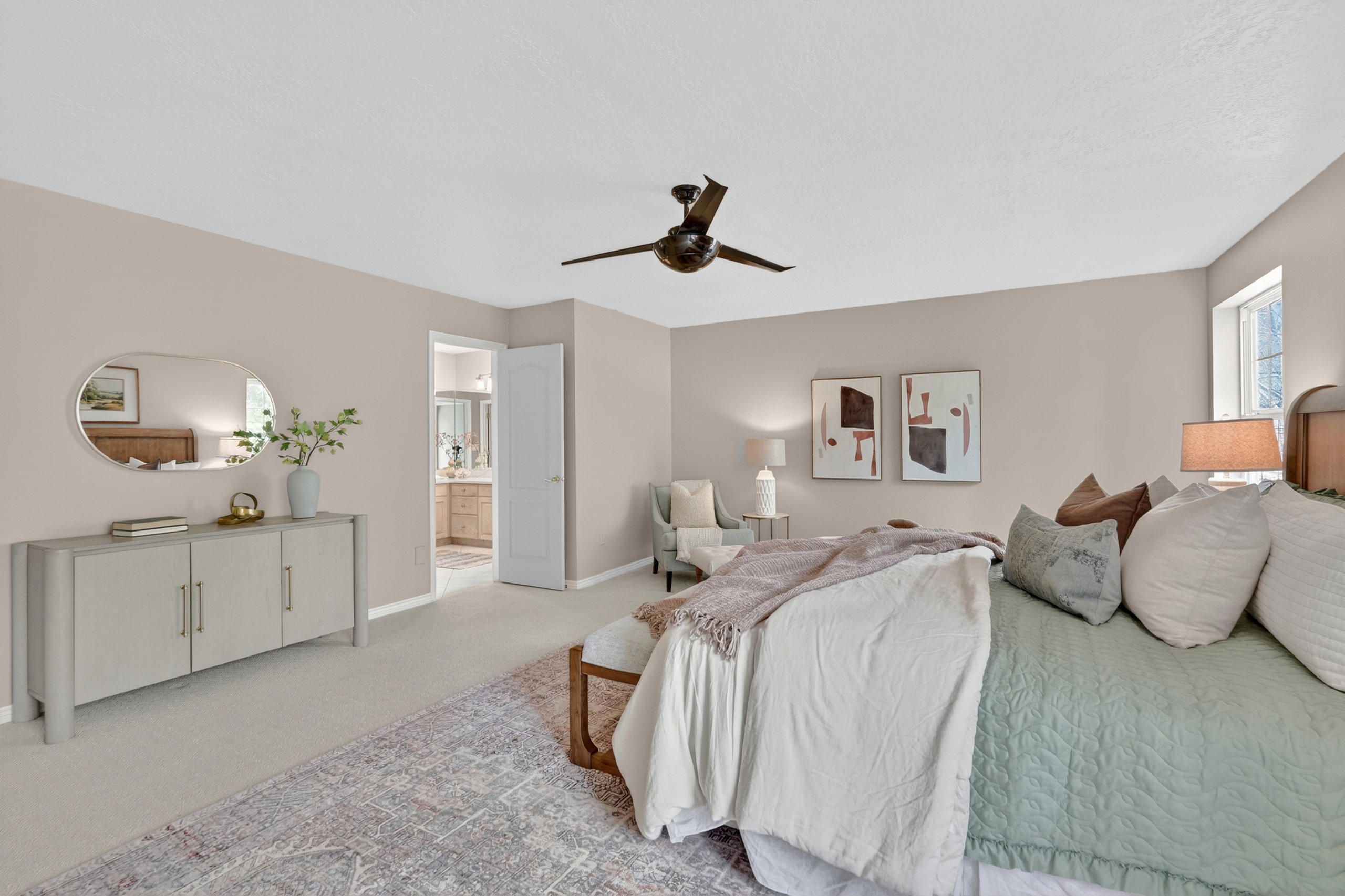 Bedroom with light-toned walls and plush carpeting
