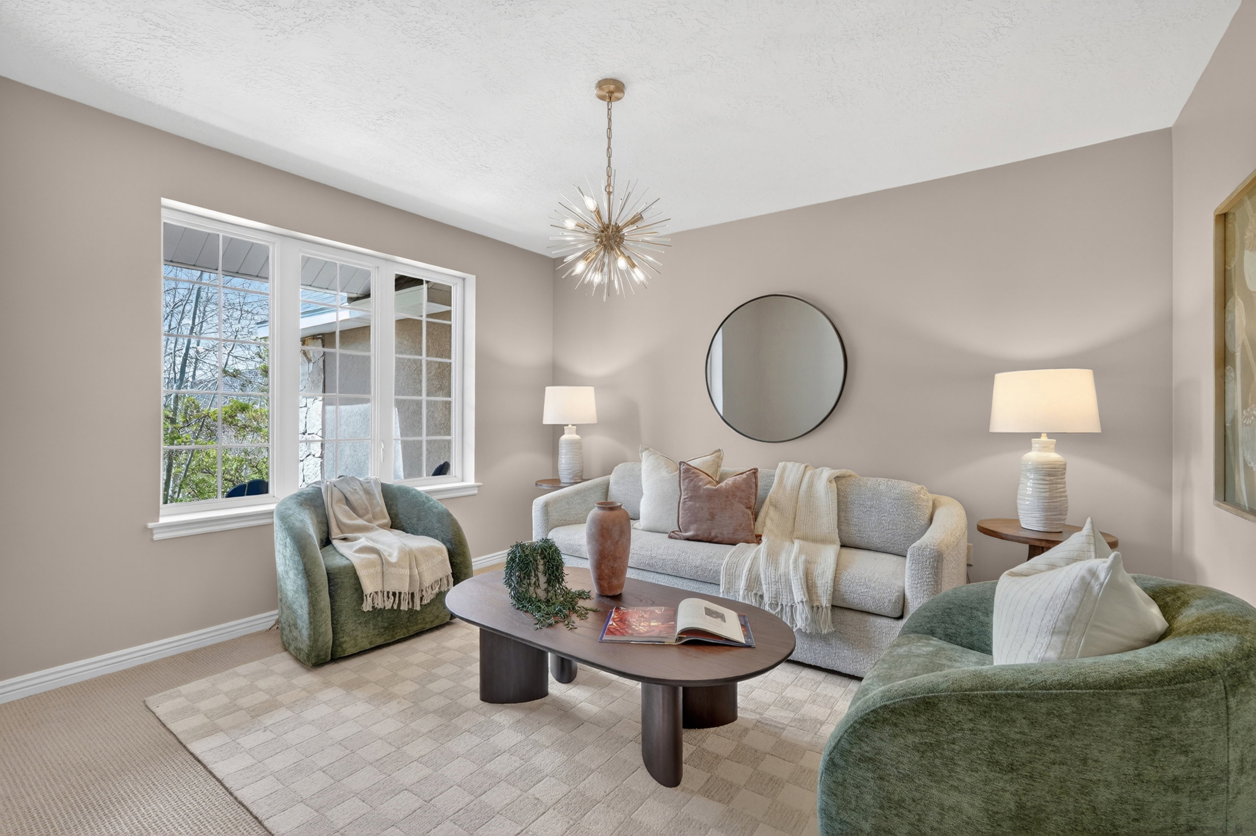 Living area featuring a multi-pane window, neutral wall paint, a built-in ceiling light fixture, and carpet flooring