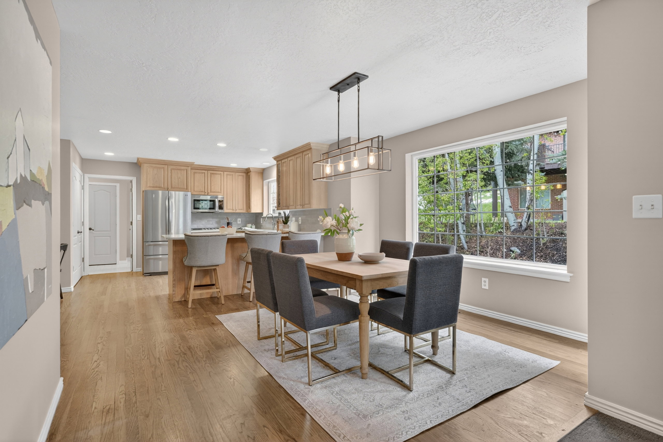 Dining area with a contemporary linear chandelier and abundant natural light