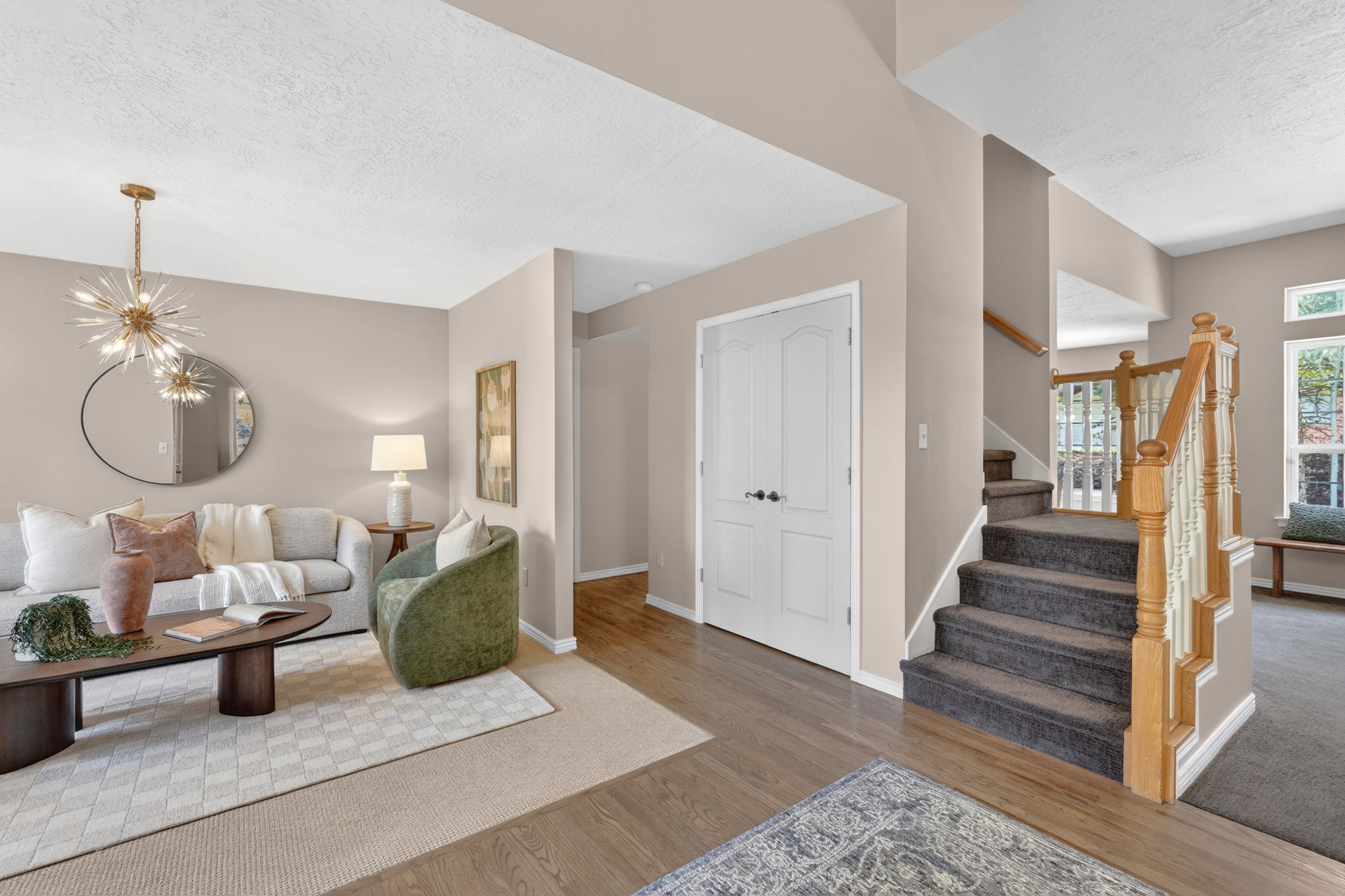 Open living area with neutral wall tones and wood-finish flooring