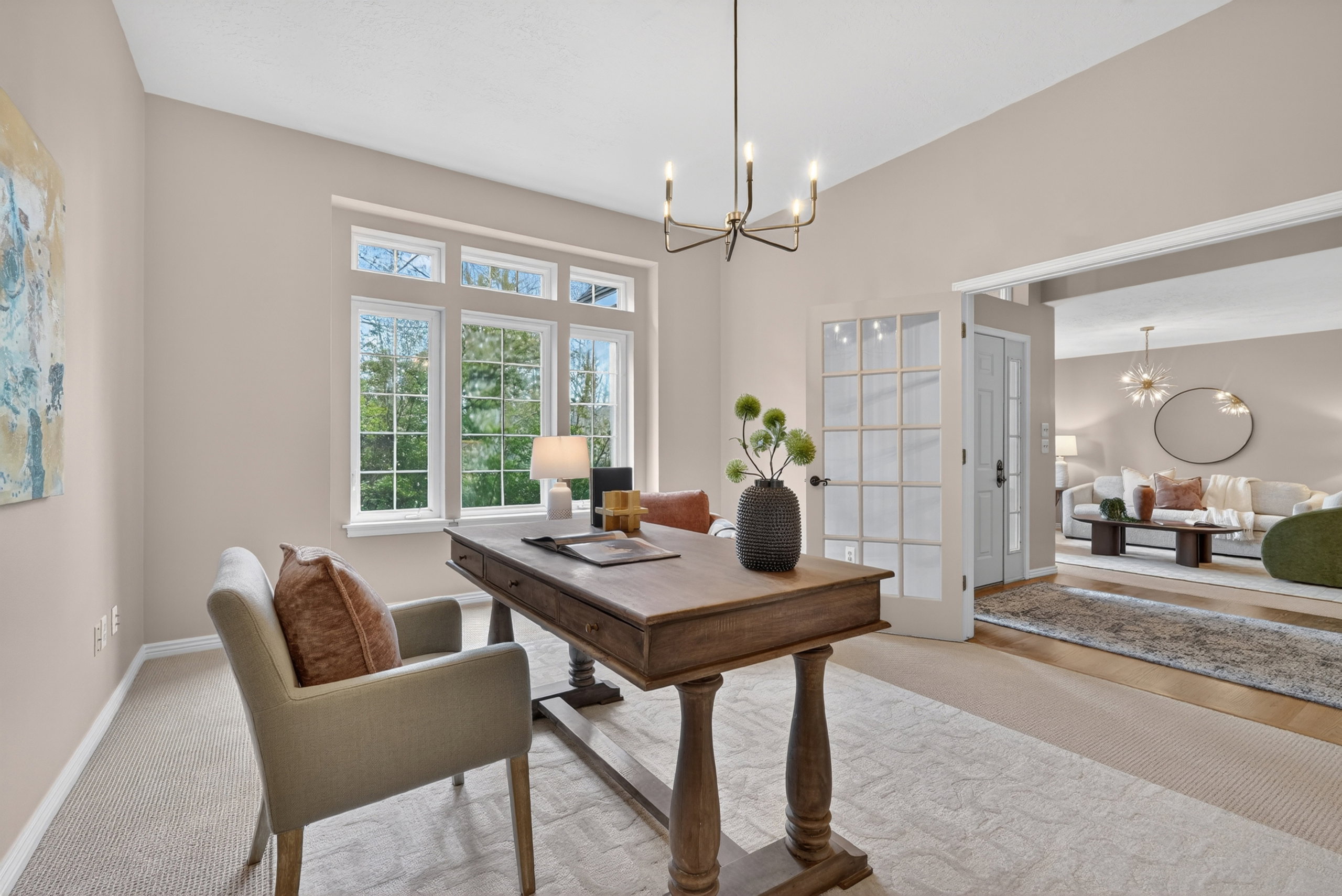 Spacious room featuring a multi-pane window, a contemporary chandelier, and carpet flooring