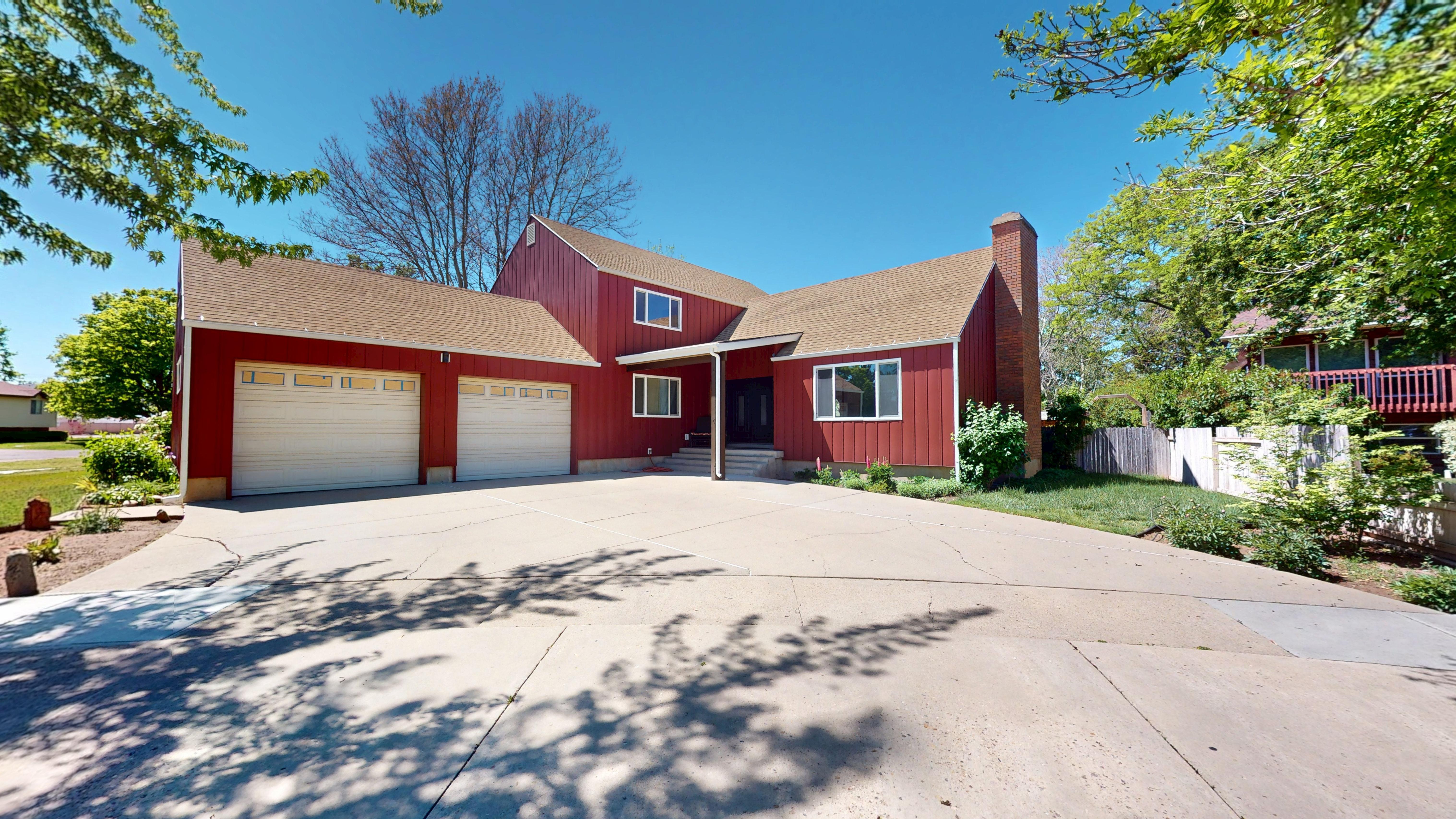 Red-sided home with a concrete driveway and an attached two-car garage