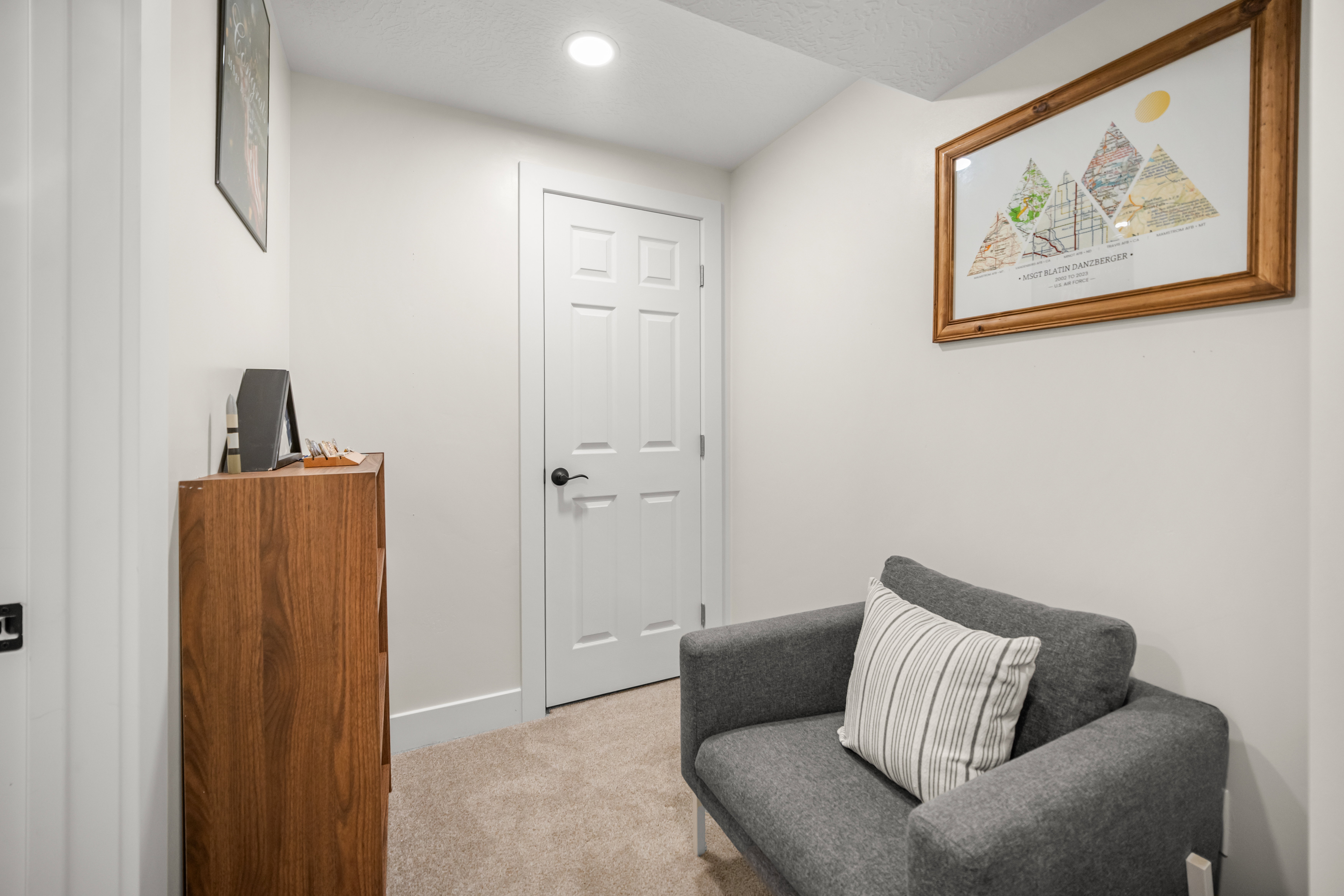 Neutral-toned walls and carpeted flooring create a versatile interior space