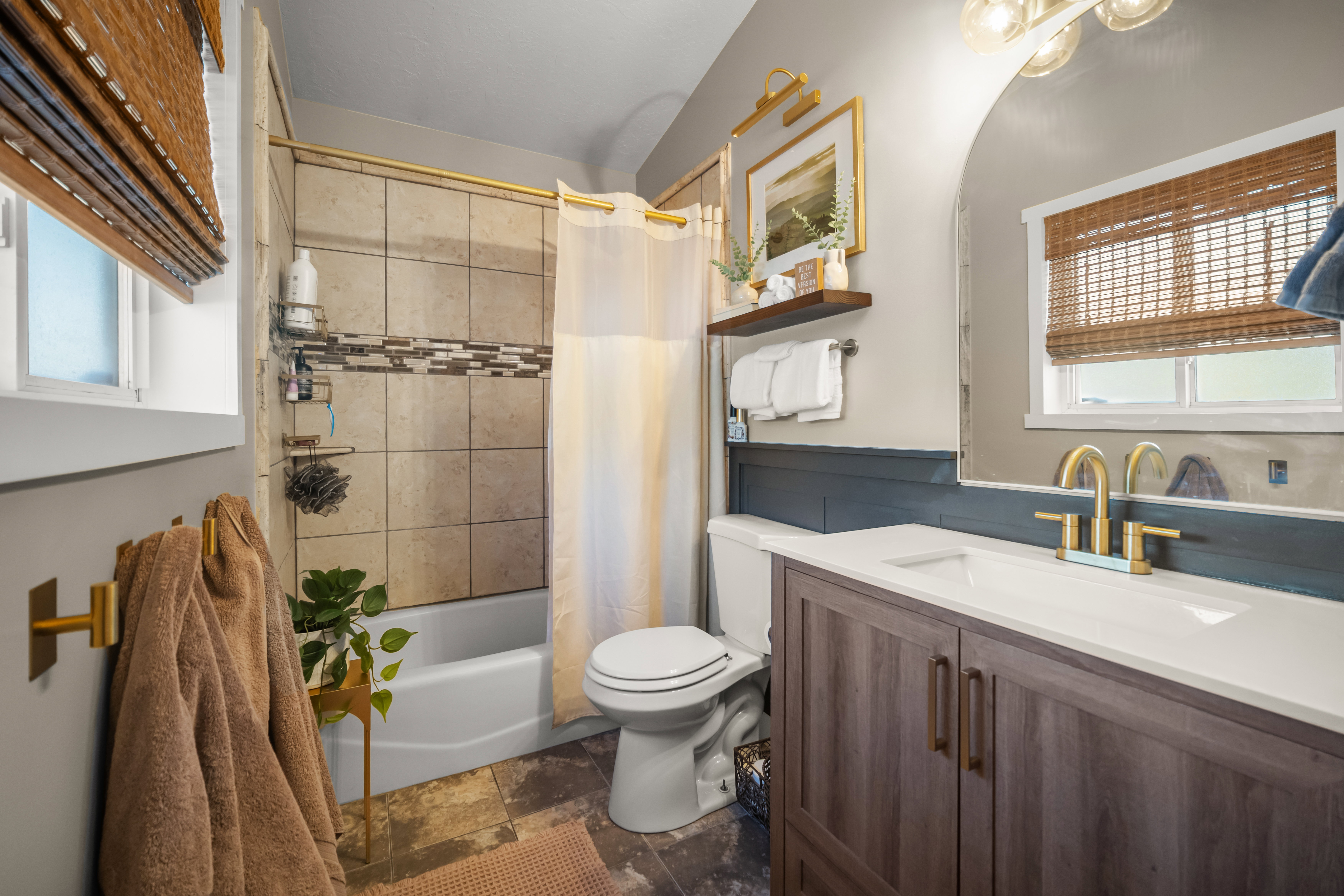 Bathroom featuring a vanity with wood-finish cabinetry, a white countertop, and a built-in sink