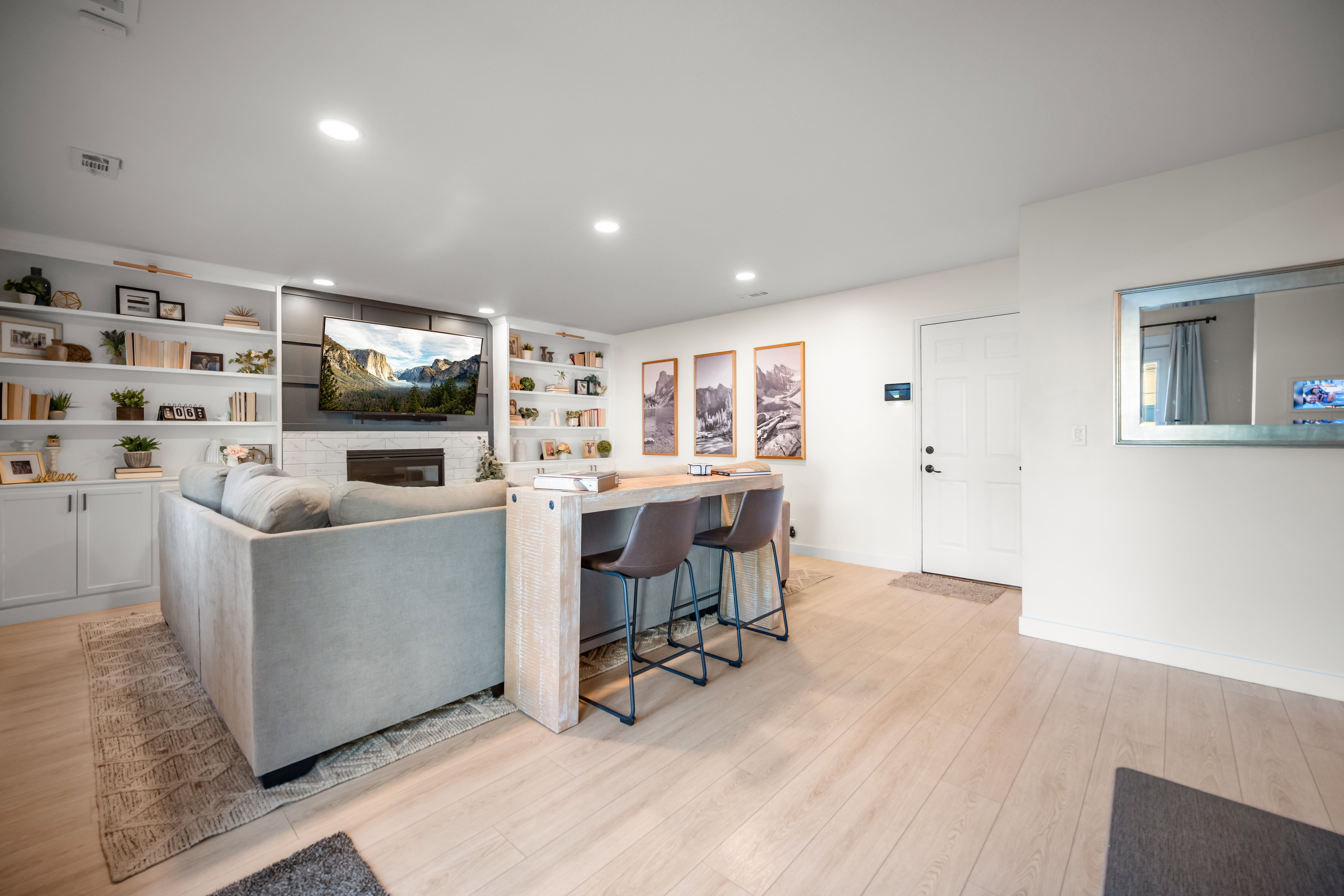 Open-concept living area with light wood-finish flooring