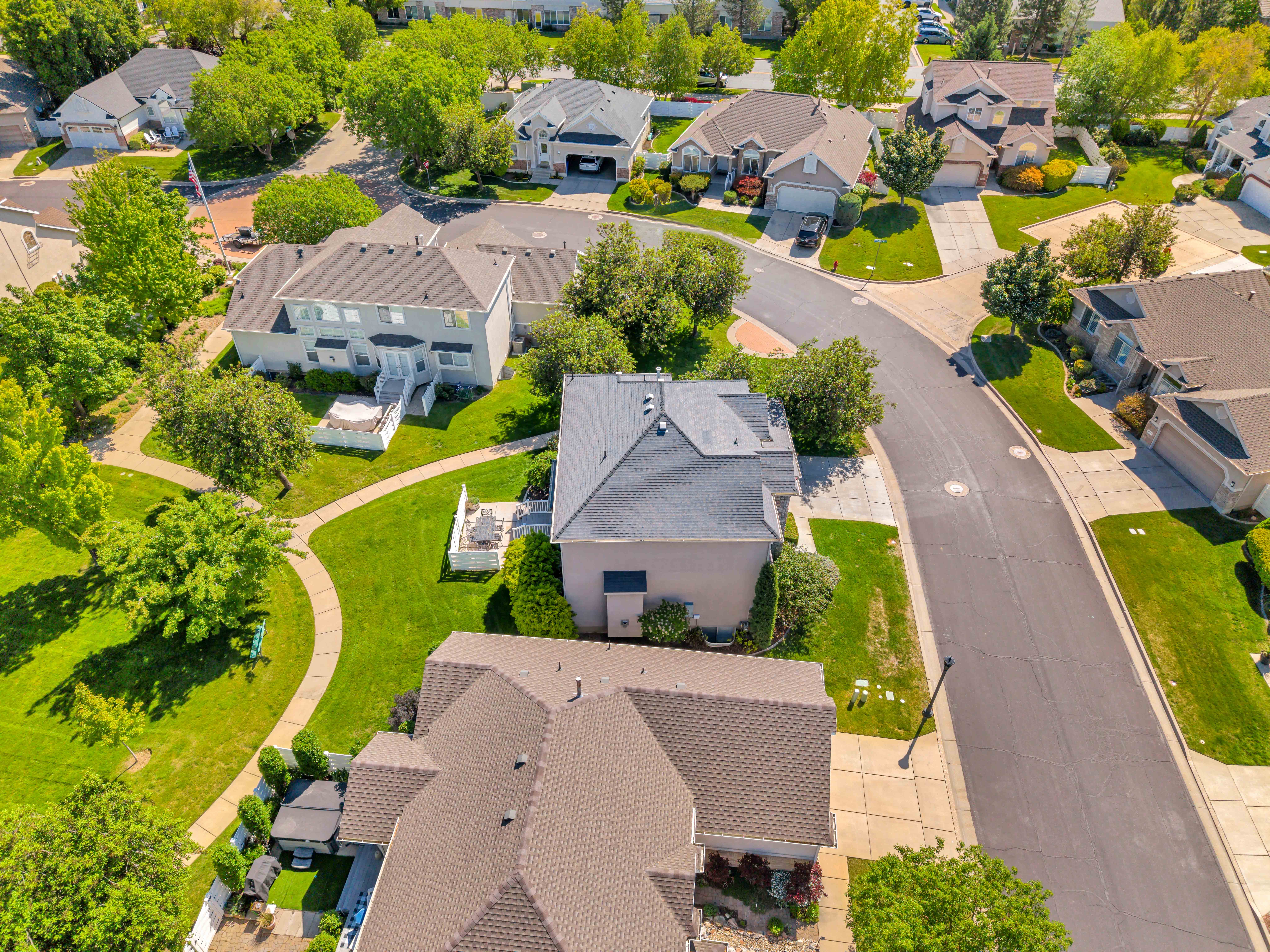 West Side View Aerial perspective of a residential neighborhood featuring asphalt streets and concrete sidewalks