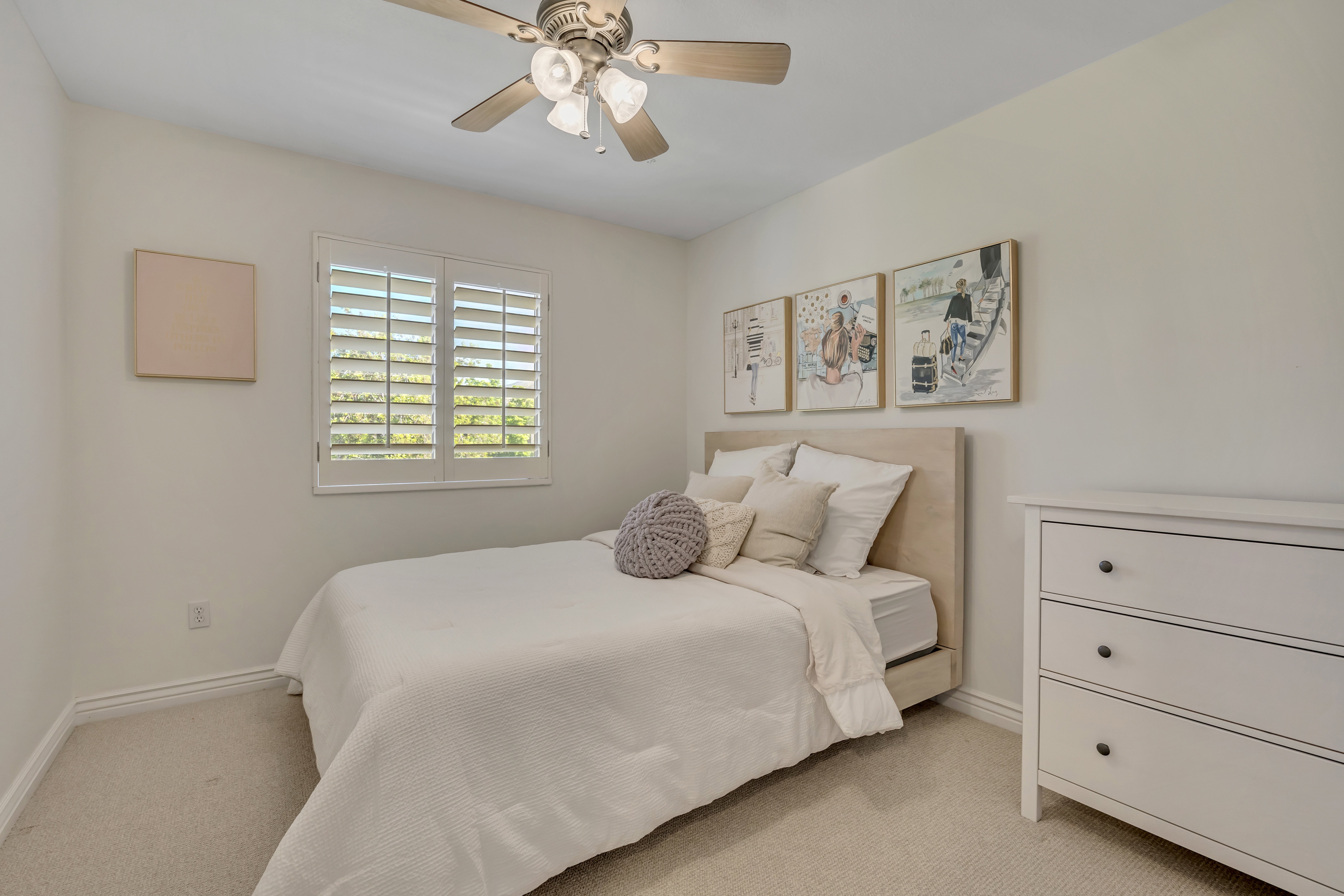 2nd upper level bedroom featuring a ceiling fan with integrated lighting, a window with plantation shutters, and light-toned walls