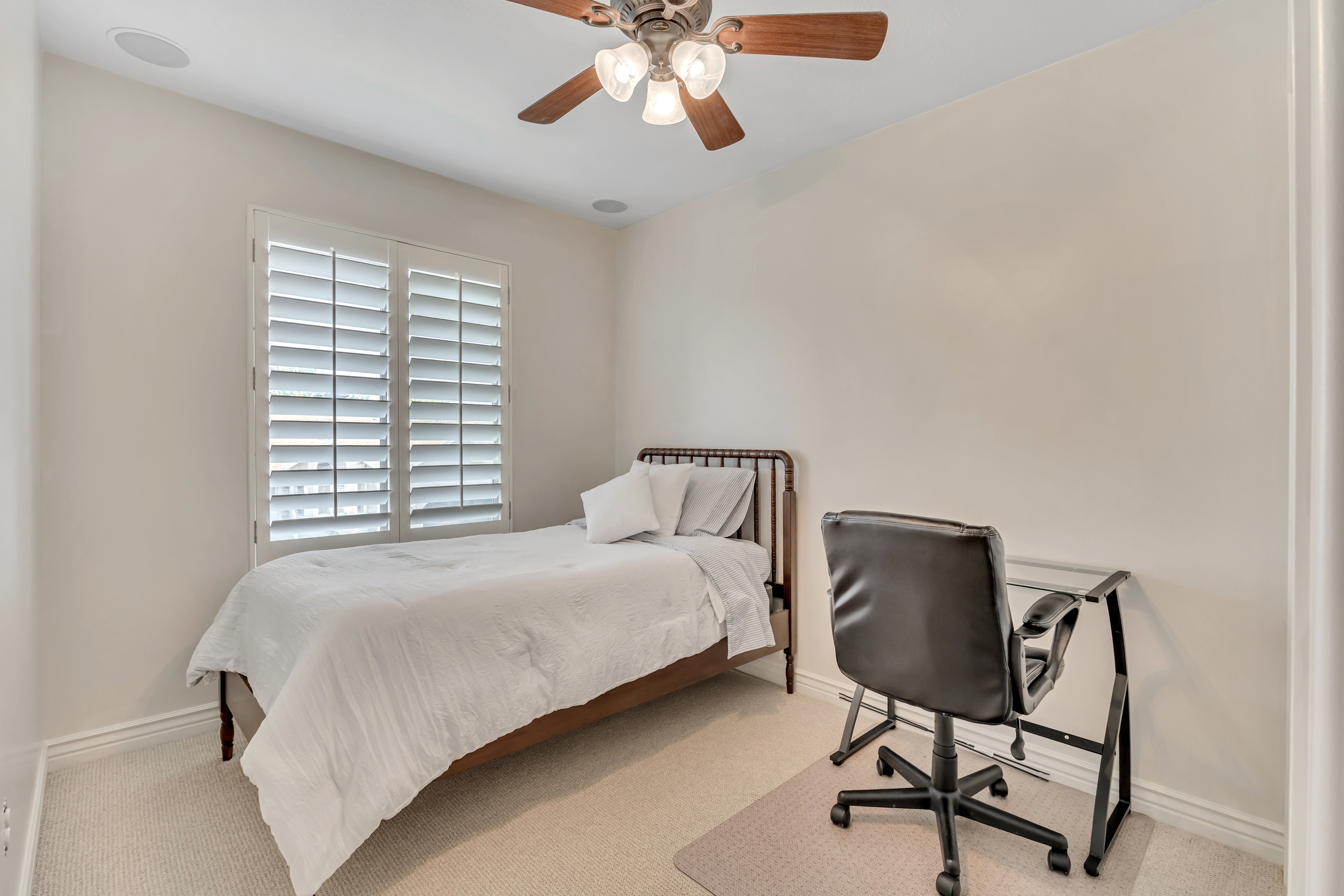 4th upper level bedroom featuring a ceiling fan with integrated lighting, recessed ceiling speakers, and a window with plantation shutters