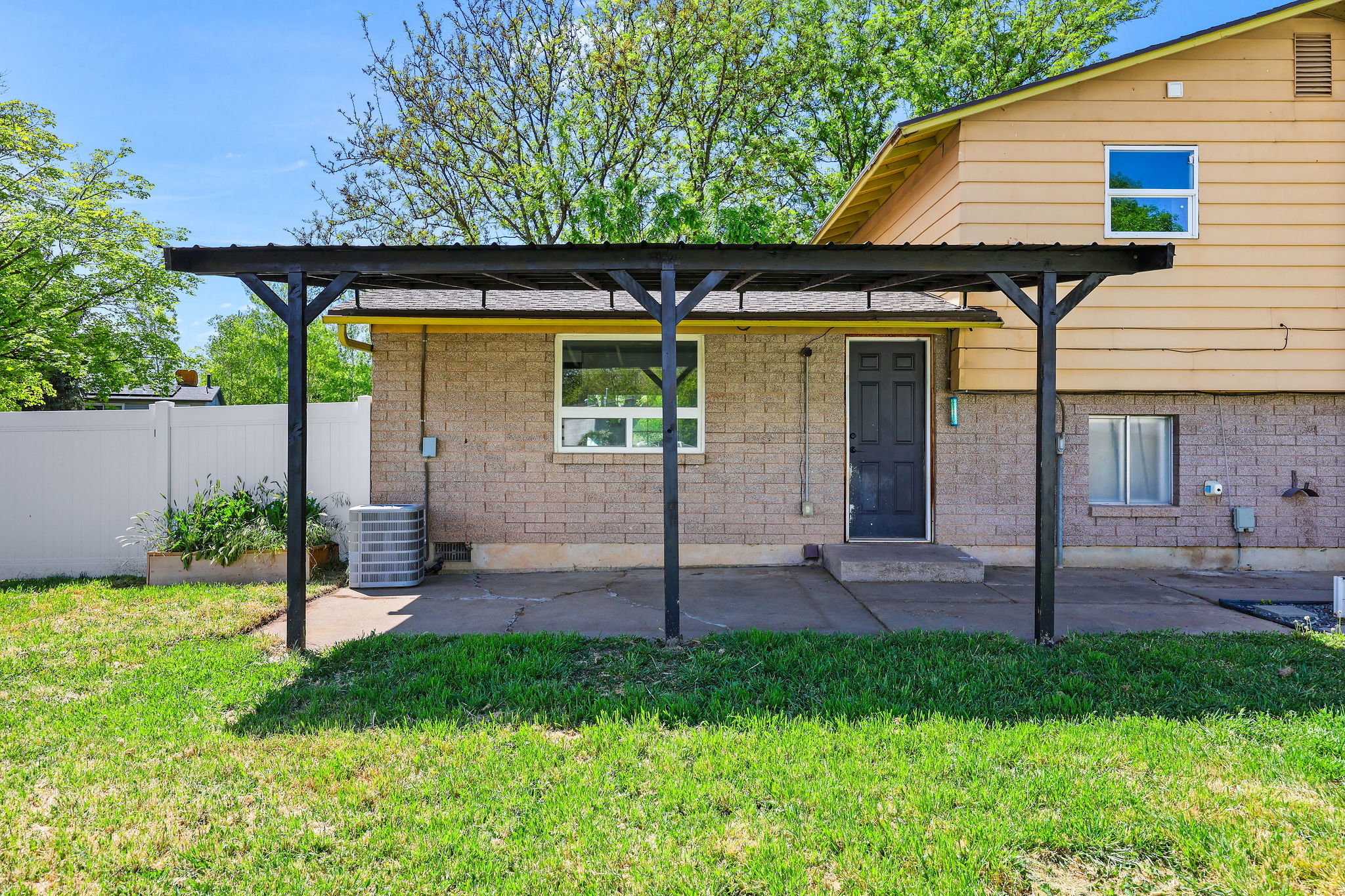 Covered patio featuring a dark-finish pergola structure