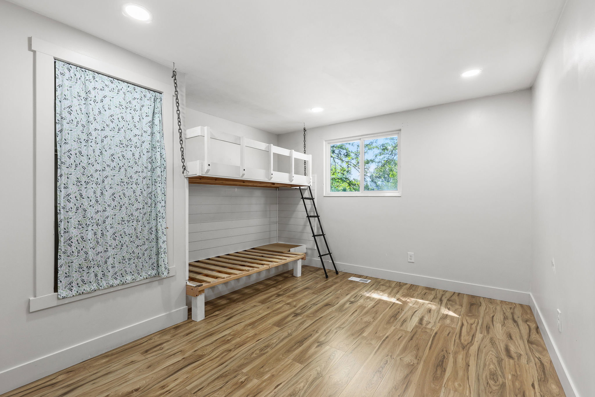 Room featuring a built-in bunk bed system with a ladder, wood-finish flooring, recessed lighting, and white walls
