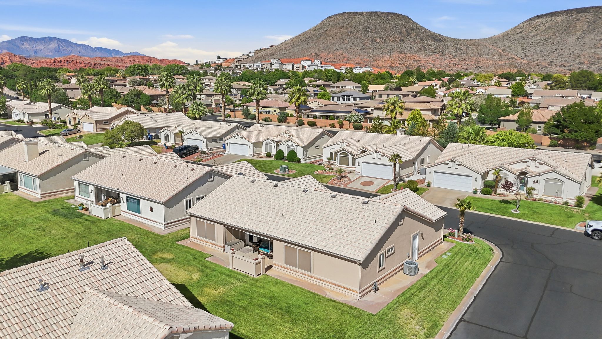 Aerial perspective showcasing a residential community with red rock mountain backdrops