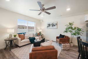 Open concept living area featuring wood-finish flooring and recessed lighting