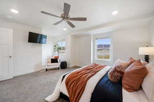 Spacious room featuring neutral carpeting, recessed lighting, and a ceiling fan