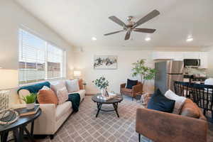 Open concept living area featuring a wide window, ceiling fan, and recessed lighting