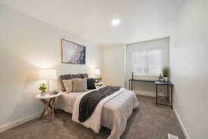 Carpeted bedroom featuring a recessed ceiling light, a window with horizontal blinds, and neutral wall tones
