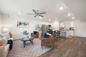 Open-concept living area featuring wood-finish flooring, recessed lighting, and a ceiling fan
