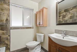 Bathroom featuring a wood-finish vanity with an integrated sink and chrome faucet