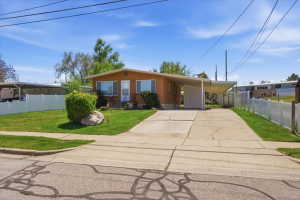 Brick exterior with a covered carport and a paved driveway