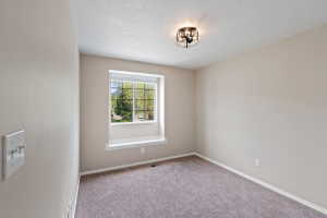Neutral-toned room featuring a window with white trim and a deep sill