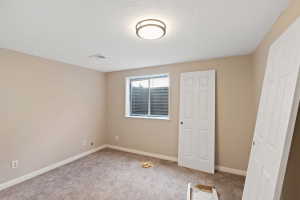 Carpeted room featuring a window, neutral wall paint, and white trim