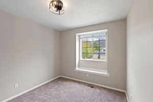 Recessed window with a built-in window seat, grid-pattern window panes, gray carpeting, neutral wall paint, and a semi-flush mount ceiling fixture