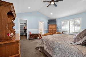 Vaulted ceiling bedroom with light blue walls and wainscoting