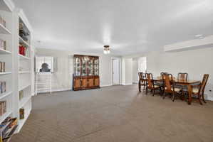 Expansive room featuring wall-to-wall carpeting and neutral-toned painted walls