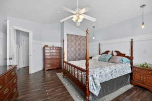 Spacious room featuring wood-finish flooring, wainscoting, and a ceiling fan with integrated lighting