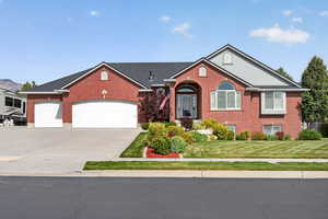 Red brick exterior featuring a multi-gabled roofline with dark shingles and light gray accents