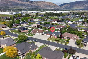 Residential neighborhood featuring mature trees and mountain backdrops