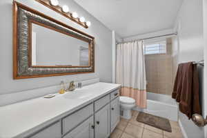 Vanity area featuring a large framed mirror, a single basin sink, and ample counter space