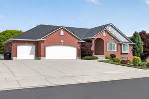 Red brick exterior with dark shingle roofing