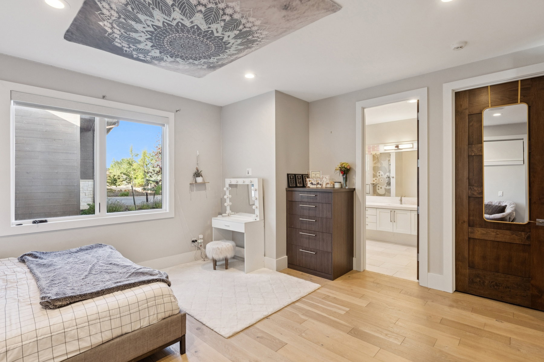 Spacious room featuring light wood-finish flooring, a large window, and recessed lighting