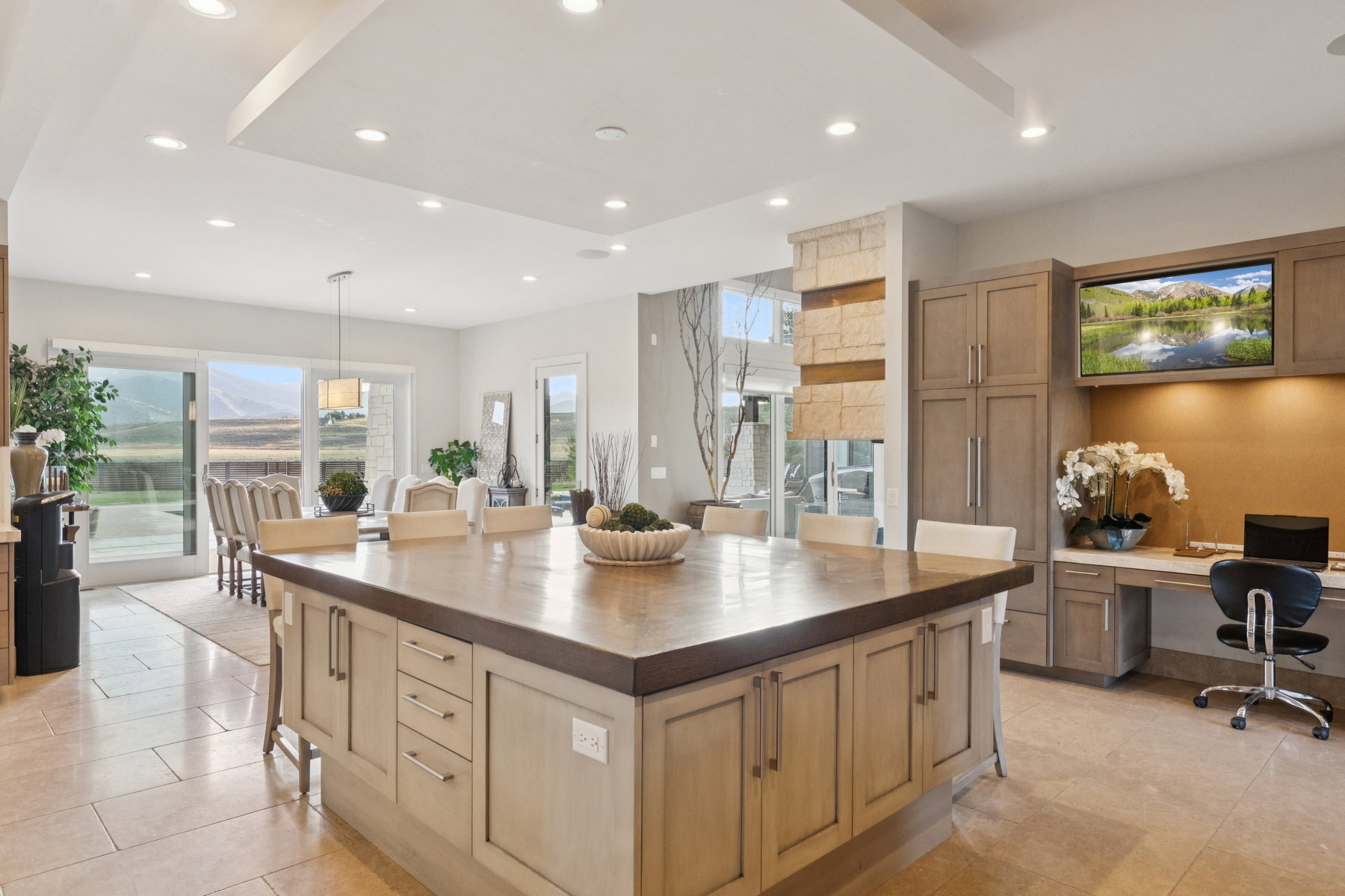 Spacious kitchen island with seating for four, wood-finish countertop, and integrated storage cabinetry