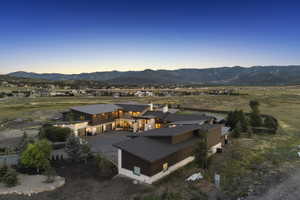 Expansive property featuring a contemporary architectural style with multiple buildings, dark-toned siding, stone accents, and varied rooflines