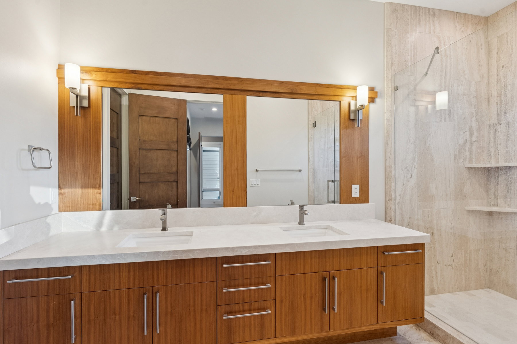 Dual vanity with a light-toned countertop and integrated sinks