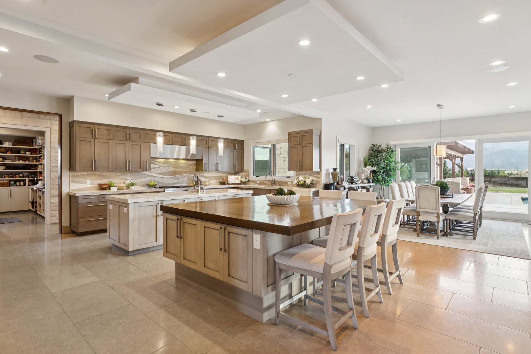 Spacious kitchen with a large center island featuring a wood-finish countertop and integrated seating