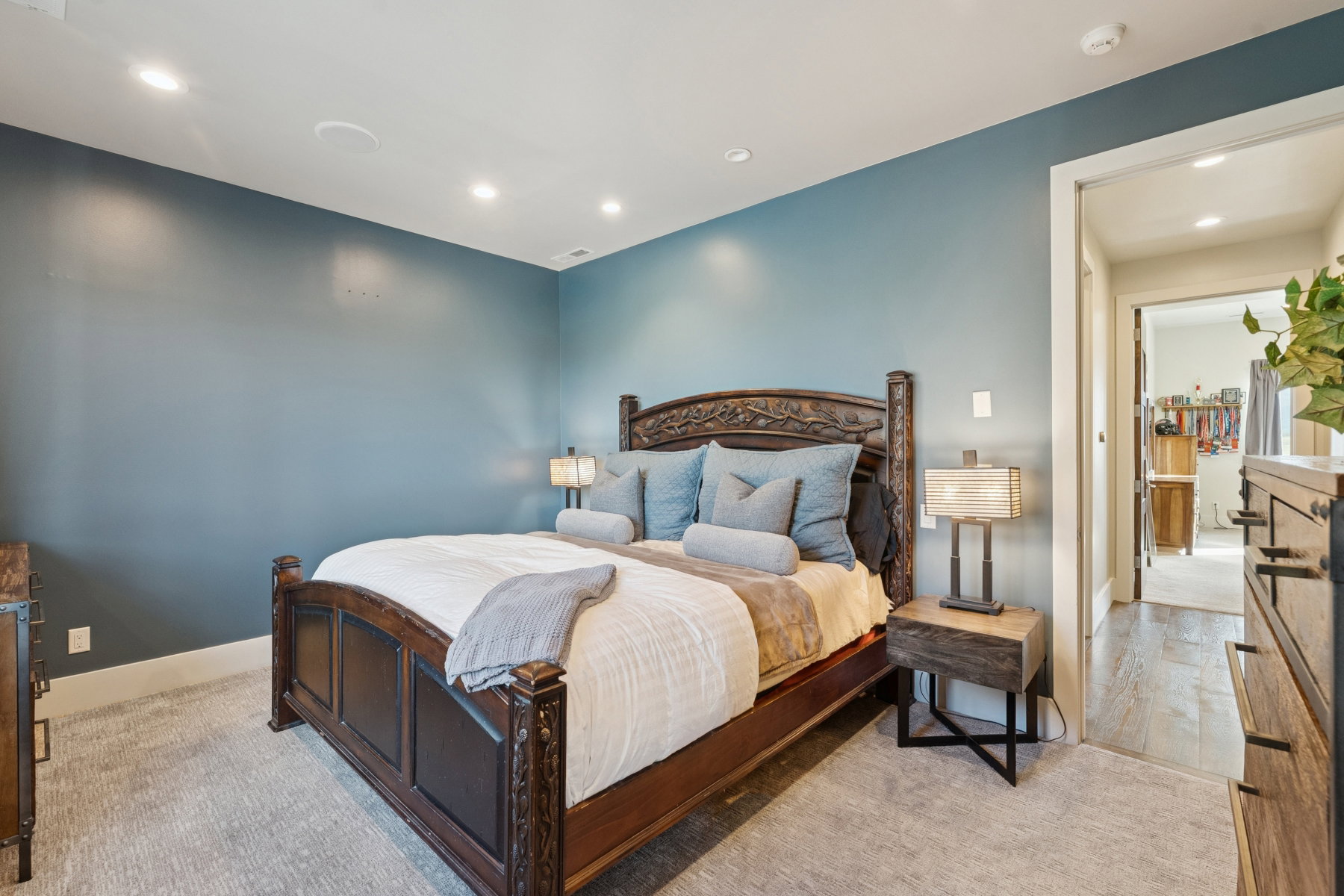Bedroom with recessed lighting, blue painted walls, and light gray patterned carpeting