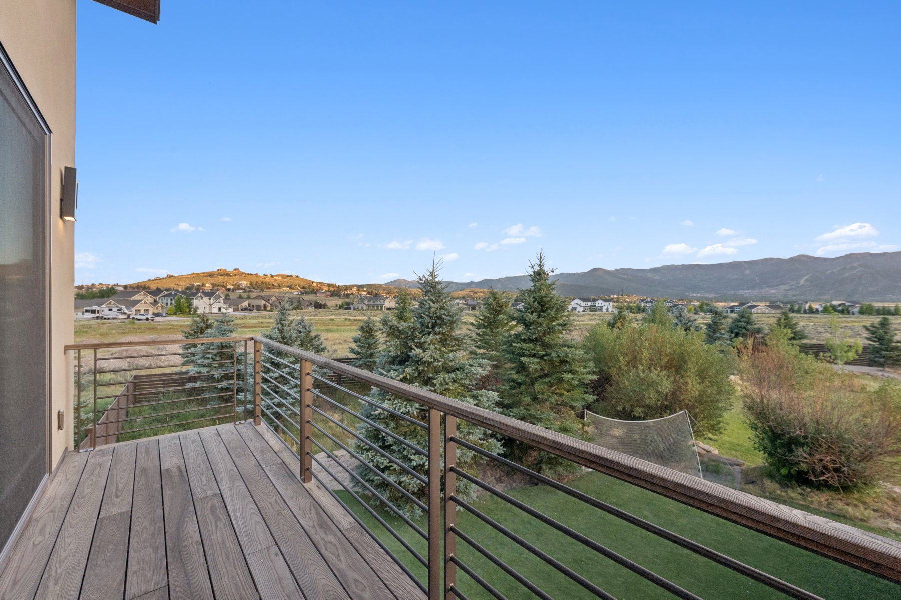 Outdoor deck with composite wood-finish flooring and a contemporary metal railing system
