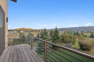 Outdoor deck with composite wood-finish flooring and a contemporary metal railing system