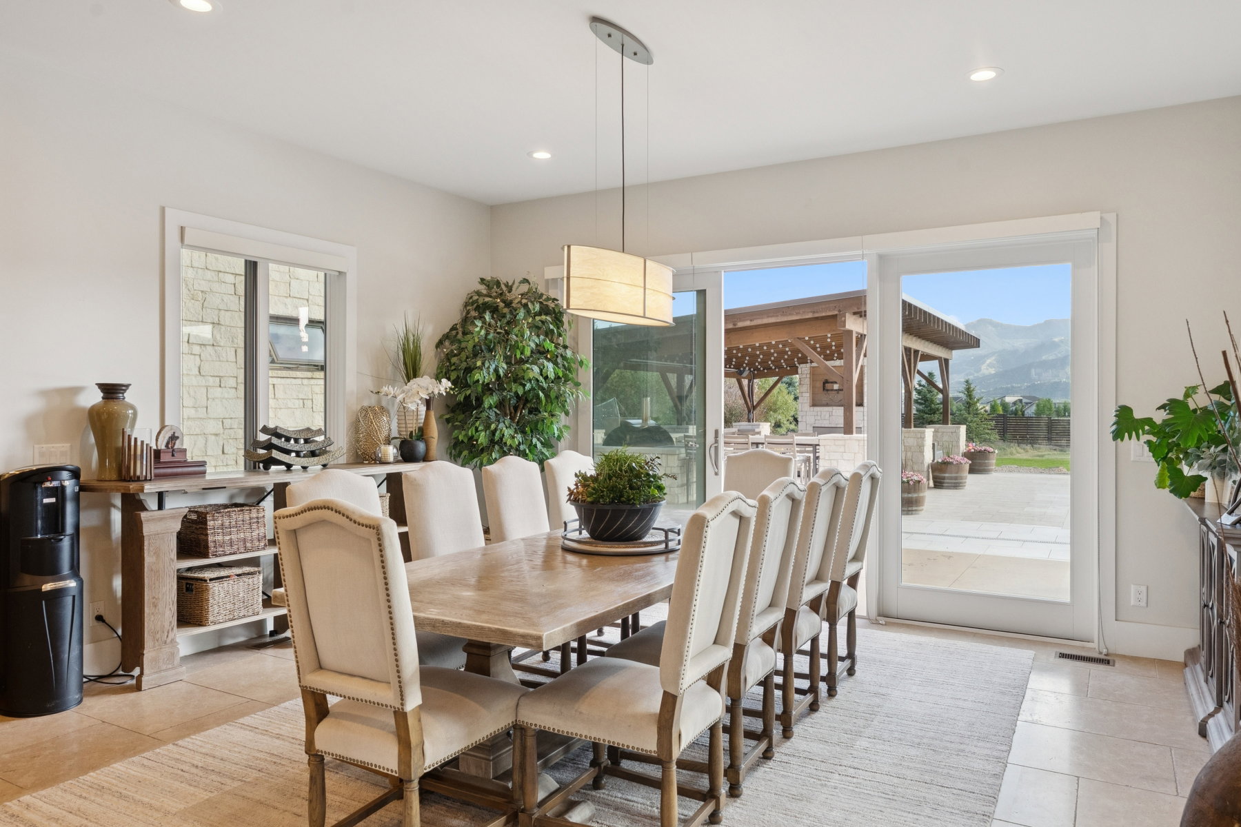 Spacious dining area featuring neutral wall tones, recessed lighting, and tile flooring