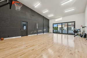 Spacious indoor recreation area with light wood-finish flooring