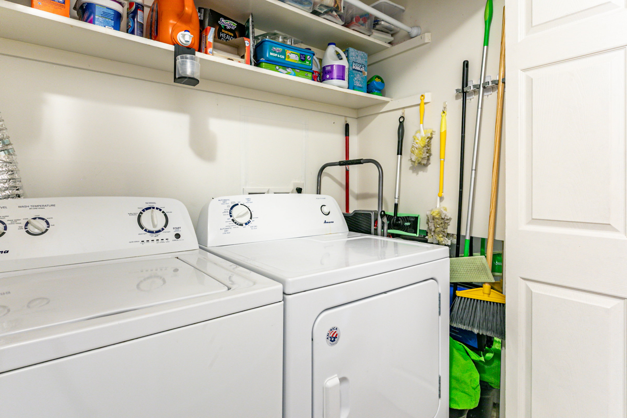 Dedicated laundry area featuring a white top-load washer and front-load dryer