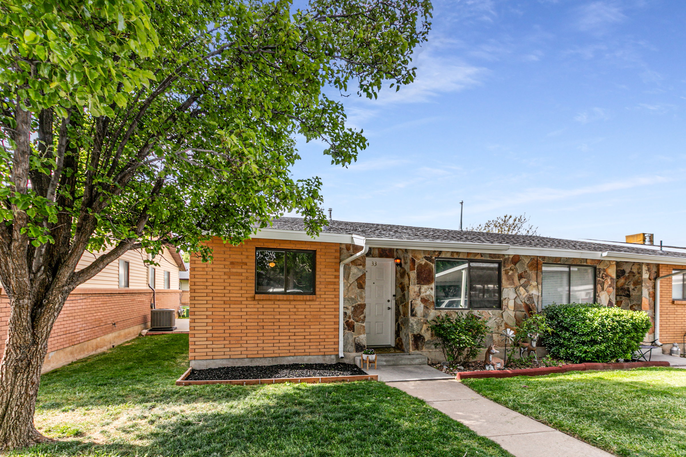 Exterior featuring a combination of natural stone veneer and brick siding